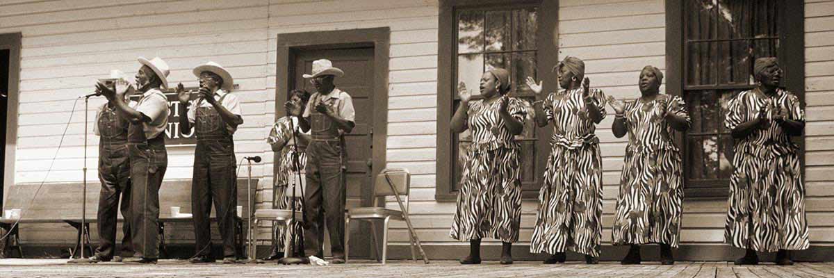 African American Men and Women Perform on the Porch of a trailer