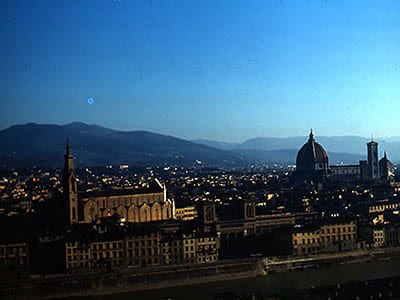 An elevated view of Florence at Night with the Arno River in the Foreground.