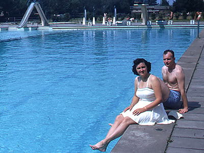 Leona and Dugald sitting at a pool. (1950s).